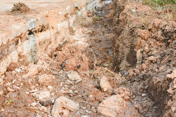 Close-up view of cracks in road under construction.