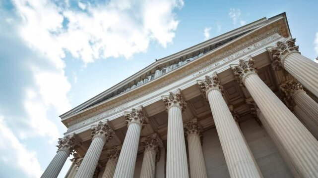 Slow motion looking up at the top of Corinthian columns in front of US Supreme Court in Washington, DC