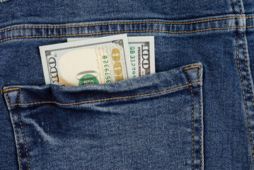 100 dollars are in the pocket of jeans. savings. theft of money. bribe. passive income.