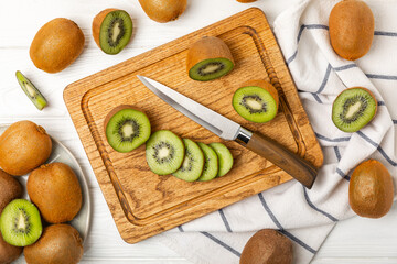 Kiwi on wooden background. Whole fruit and slices pieces of green kiwi on table. fresh ripe juicy kiwi. Tropical fruit. Organic fruit. Healthy eating. Space for text. Copy space