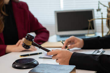 Office of the Legal Counsel: The judge's gavel is placed on the table, symbolizing justice and the authority of the court in a formal manner.