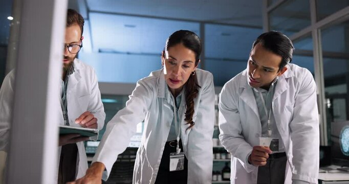 Scientist, meeting and teamwork with technology in lab for pharmaceutical review, medical research or tablet. Night, people and interactive display for studying science, collaboration and results
