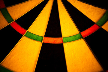 Full-Frame Close-Up of a Vintage Dartboard with Warm Lighting and Textured Surface