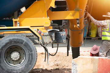 Engineers are overseeing the pouring of concrete.