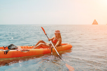 Kayak sea woman. Happy attractive woman with long hair in red swimsuit, swimming on kayak. Summer...
