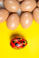 Top view of a colorful decorated easter egg on a colored background. Concept of celebrating the easter holiday