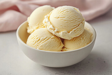 Bowl of vanilla ice cream topped with fresh strawberries and chocolate syrup on a wooden table.
