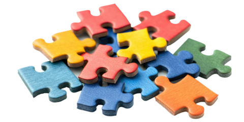 Colorful puzzle pieces scattered on a white surface, cut out
