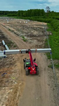 Vertical drone video observed as it manipulates Front telescopic handler