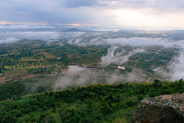 Vista of the Land: A breathtaking landscape unfolds beneath a dramatic sky. The expansive scene...