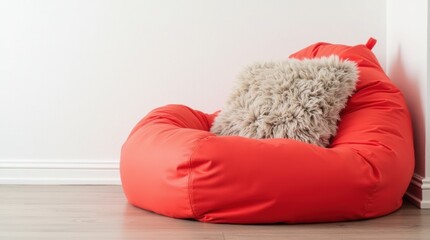 Single bright red bean bag with a fluffy cushion on top, white wall background