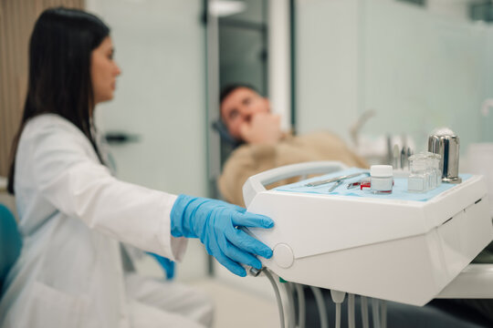 Dentist preparing tools for teeth treatment in dental clinic