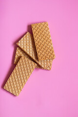 Waffles on a smooth pink background. perfect for illustrating a minimalist breakfast or dessert idea.