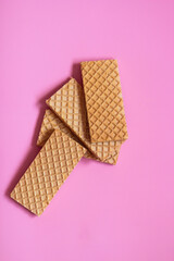 Waffles on a smooth pink background. perfect for illustrating a minimalist breakfast or dessert idea.