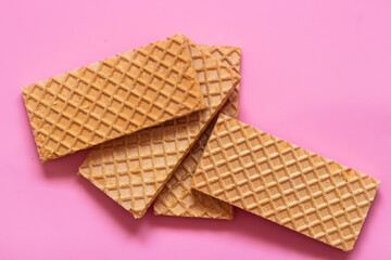 Waffles on a smooth pink background. perfect for illustrating a minimalist breakfast or dessert idea.