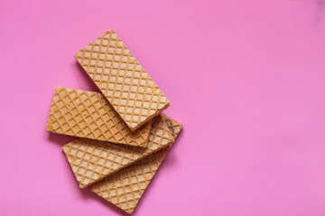 Waffles on a smooth pink background. perfect for illustrating a minimalist breakfast or dessert idea.