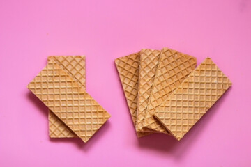 Waffles on a smooth pink background. perfect for illustrating a minimalist breakfast or dessert idea.