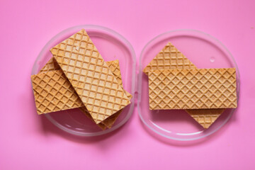 Waffles on a smooth pink background. perfect for illustrating a minimalist breakfast or dessert idea.