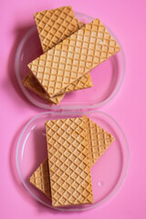 Waffles on a smooth pink background. perfect for illustrating a minimalist breakfast or dessert idea.