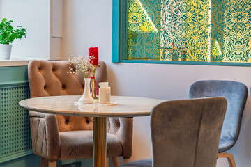 Cozy Cafe Corner: Elegant Cafe Space with Vintage Chairs and Ornate Wallpaper