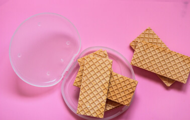 Waffles on a smooth pink background. perfect for illustrating a minimalist breakfast or dessert idea.