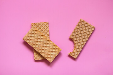Waffles on a smooth pink background. perfect for illustrating a minimalist breakfast or dessert idea.