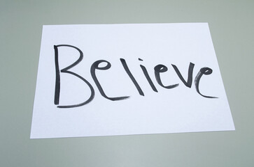 A simple yet powerful declaration of belief, hand-written in bold black ink on a crisp white paper...
