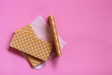 Waffles on a smooth pink background. perfect for illustrating a minimalist breakfast or dessert idea.