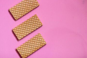 Waffles on a smooth pink background. perfect for illustrating a minimalist breakfast or dessert idea.