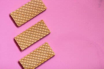 Waffles on a smooth pink background. perfect for illustrating a minimalist breakfast or dessert idea.