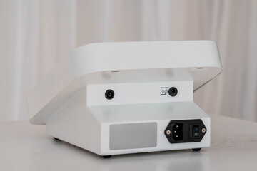 Backside View of Modern White Electronic Device with Power Switch and Connection Ports