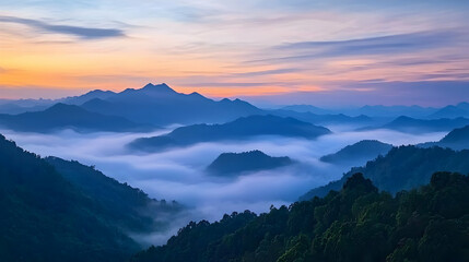 Fototapeta premium Elevated Mountain Landscape with Foggy Valleys Beneath a Vibrant Sunrise Hues in the East