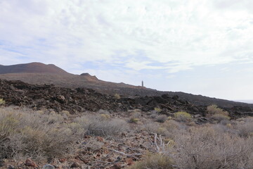 El Faro de Punta Orchilla lighthouse with red volcanic scenery in summer, El Hierro, Canary...