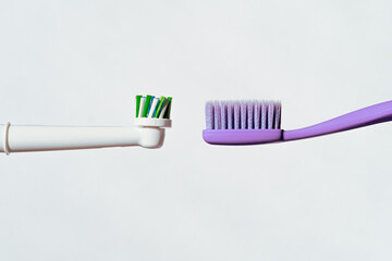 New electric automatic and manual toothbrushes without tothpaste on a white background on the same level.