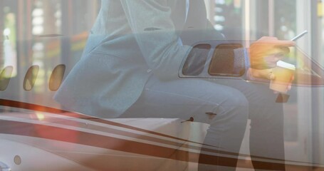 Using smartphone with airplane overlay, businessperson symbolizing travel and communication - Powered by Adobe