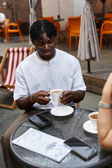 Charming moments shared between two handsome men over coffee in a cozy cafe on a sunny afternoon