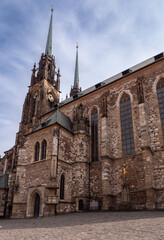 Obraz premium Brno, Czech republic - 03222025: Front view of the Cathedral of St. Peter and Paul in Brno, Czech Republic, showing detailed Gothic architecture and tall spires under a partly cloudy sky.