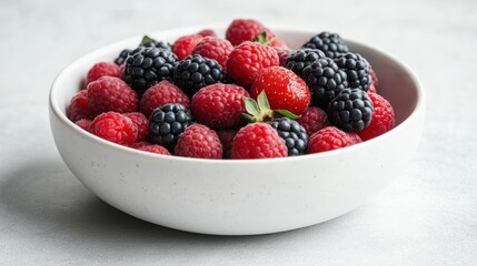 A minimalist white ceramic bowl filled with fresh berries, isolated on white