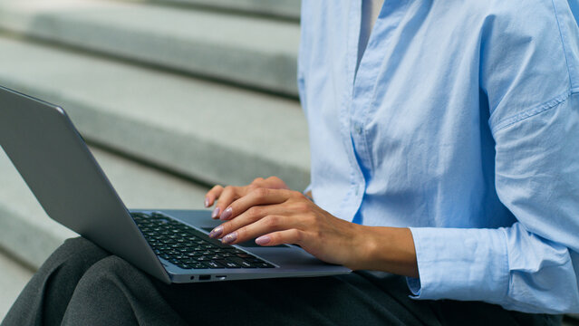 African American woman female business girl businesswoman freelancer employer distant work in city outdoors urban Wi-Fi connection typing laptop computer wireless job online chatting client remote