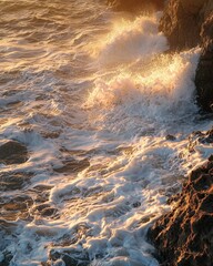 Fototapeta premium Golden sunlight illuminates waves crashing against rocky coastal cliffs