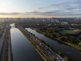 Rising sun on a river within the metropolis of São Paulo with the Pinheiros riverside.