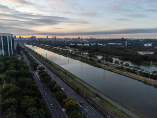 Rising sun on a river within the metropolis of São Paulo with the Pinheiros riverside.