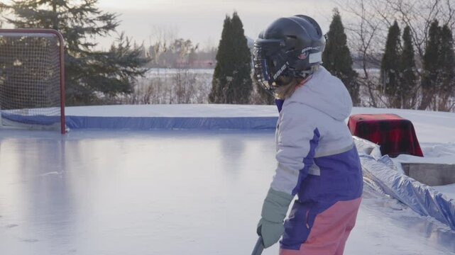 Little girl with boots playing hockey