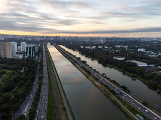 Rising sun on a river within the metropolis of São Paulo with the Pinheiros riverside.