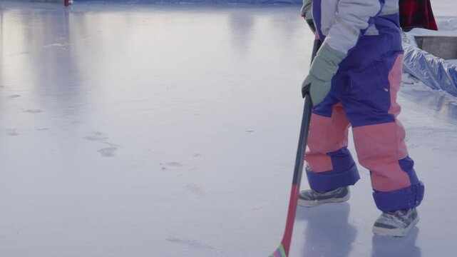Slow motion girl on ice hockey player with boots