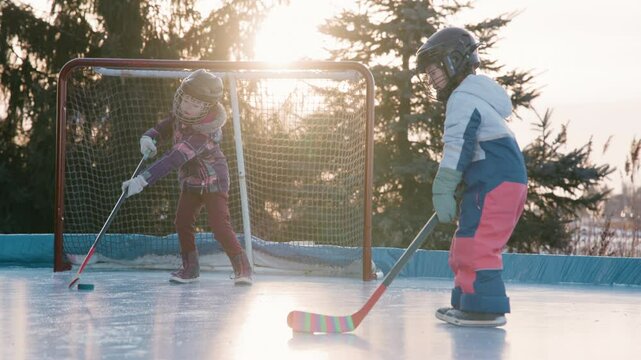 Sisters on the rink playing hockey