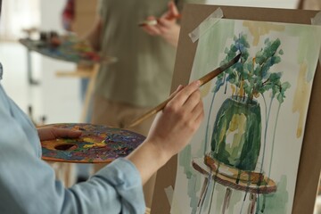 Woman painting during class in studio, closeup