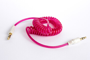 Pink standard 3.5mm Male to Male audio cable isolated on white.