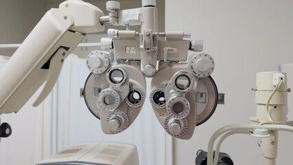 Close-up of a phoropter used for eye exams in an optometry clinic. The device is essential for measuring vision and determining eyeglass prescriptions.