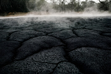Cracked dry soil in the geothermal area of Rotorua, New Zealand, showcasing the effects of geothermal activity